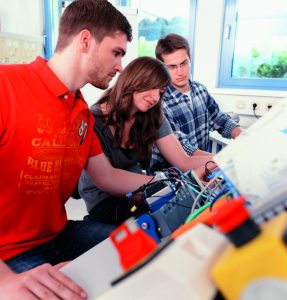 students working together in mechatronics laboratory of college, close up